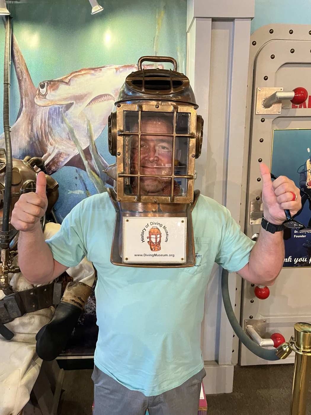 Mike trying a vintage diving helmet at the History of Diving Museum